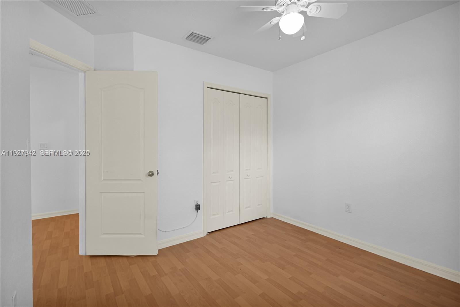 12832 Southwest 30th Street, Unit 118 Miramar, FL 33027 - Photo 18 of 29 an empty room with a fan and a chandelier fan