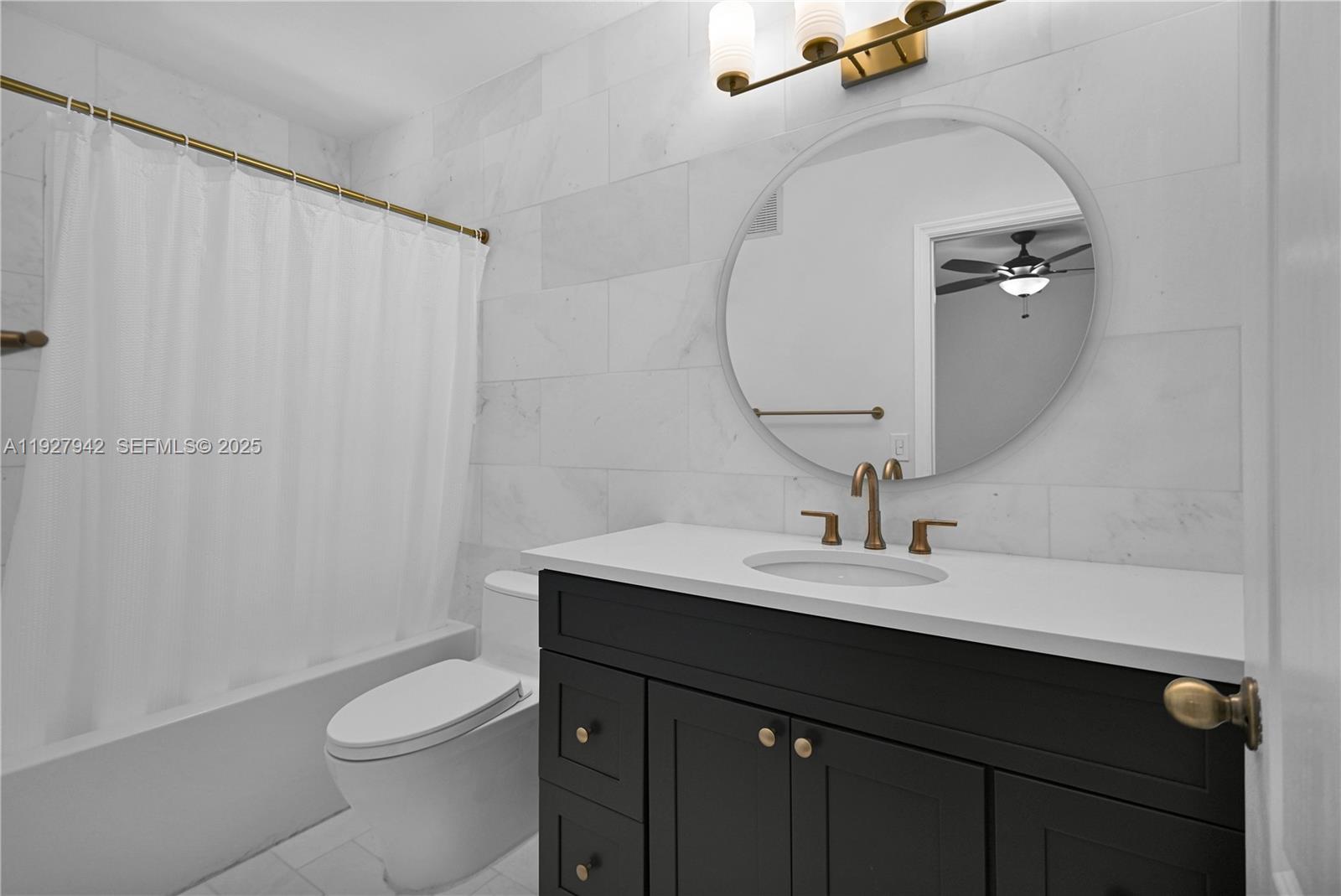 12832 Southwest 30th Street, Unit 118 Miramar, FL 33027 - Photo 20 of 29 a bathroom with a sink vanity mirror and toilet