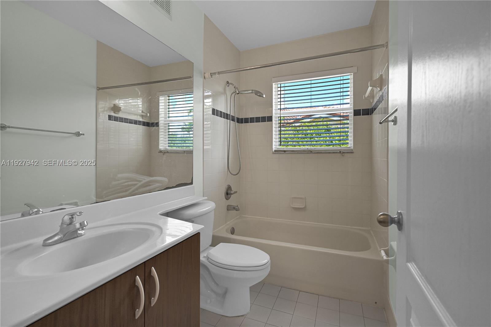 12832 Southwest 30th Street, Unit 118 Miramar, FL 33027 - Photo 23 of 29 a bathroom with a sink toilet and shower