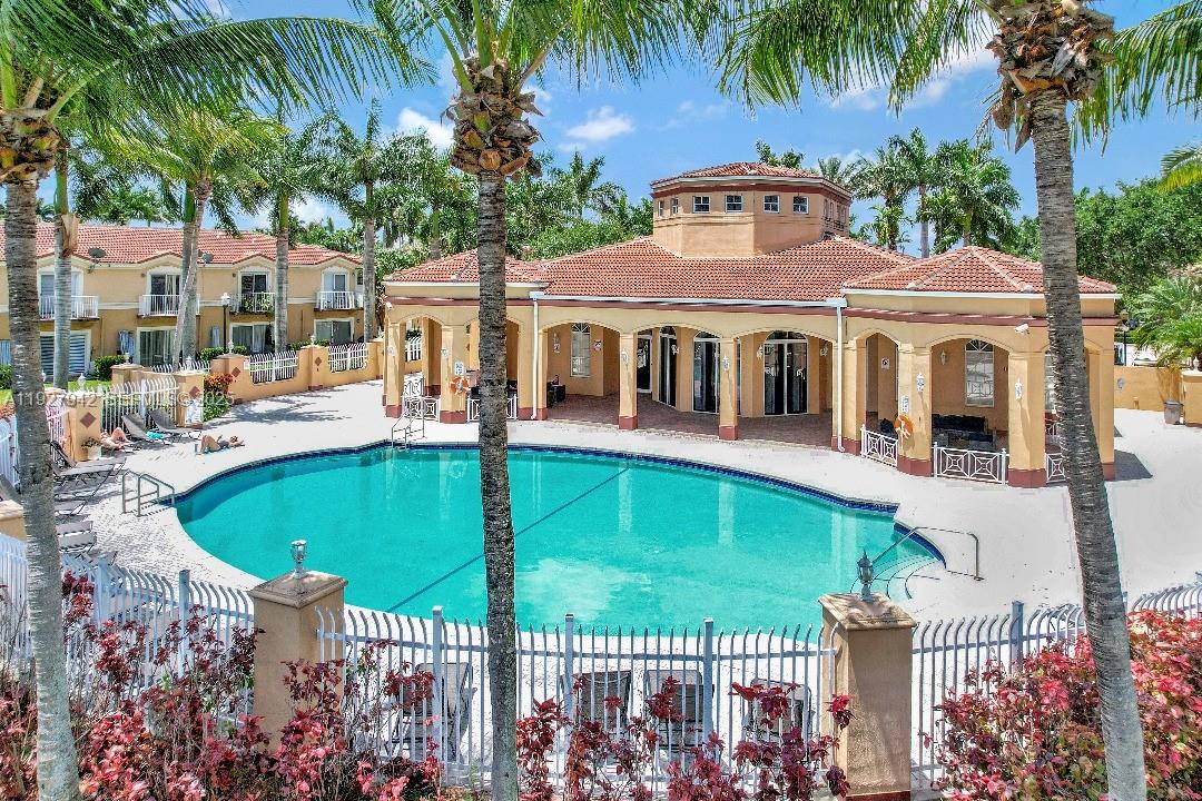 12832 Southwest 30th Street, Unit 118 Miramar, FL 33027 - Photo 27 of 29 a front view of a house with a garden and lake view