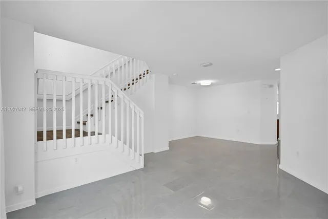 a view of an empty room with white walls
