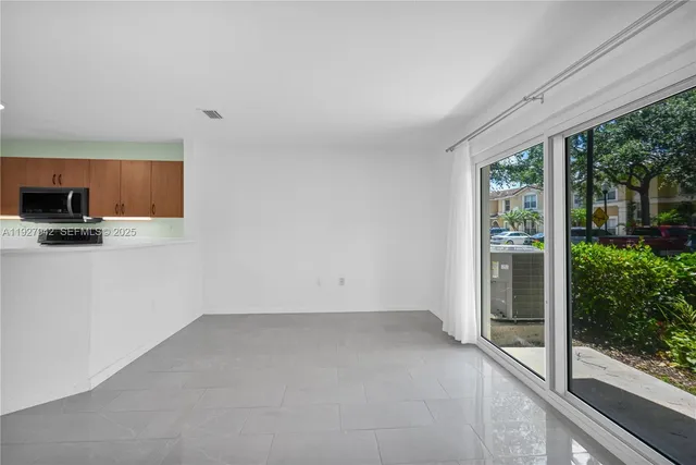 a view of a kitchen with a sink and a window