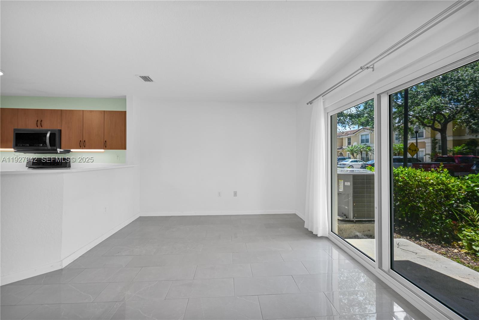12832 Southwest 30th Street, Unit 118 Miramar, FL 33027 - Photo 6 of 29 a view of a kitchen with a sink and a window