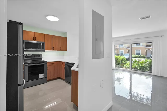 a kitchen with a refrigerator and window