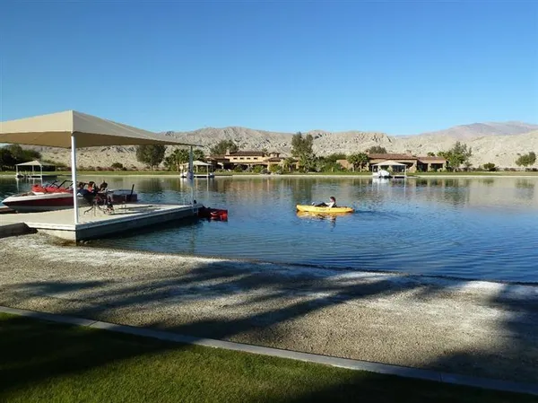 an aerial view of a swimming pool and lake