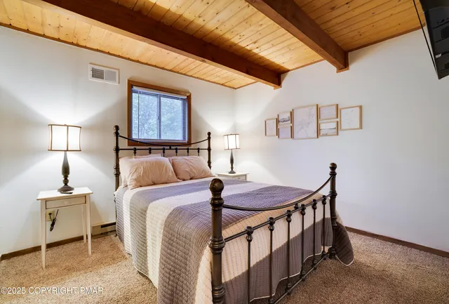 a bedroom with a bed and a table