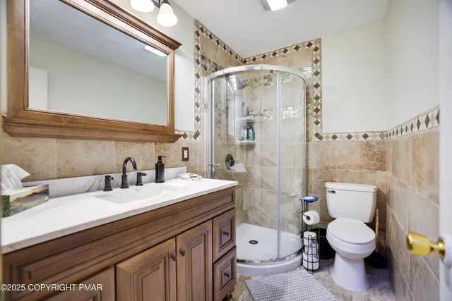 a bathroom with a sink toilet vanity and shower