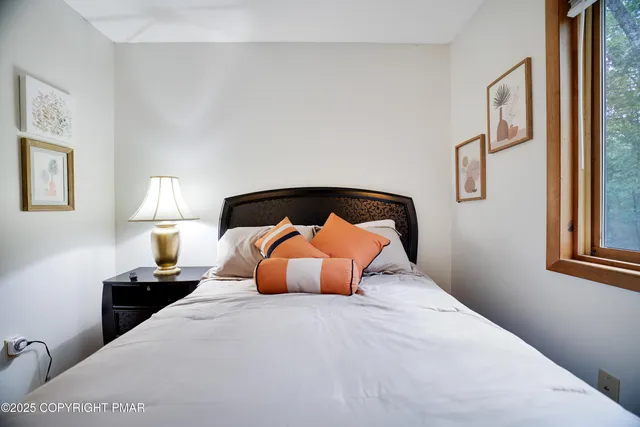 a bedroom with a bed and window