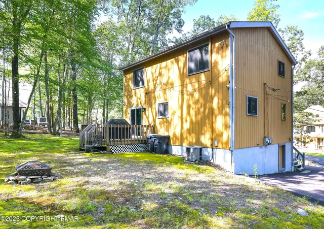 a view of backyard with tub and trees around
