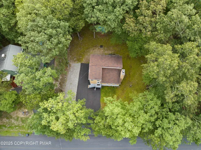 an aerial view of a house with a yard