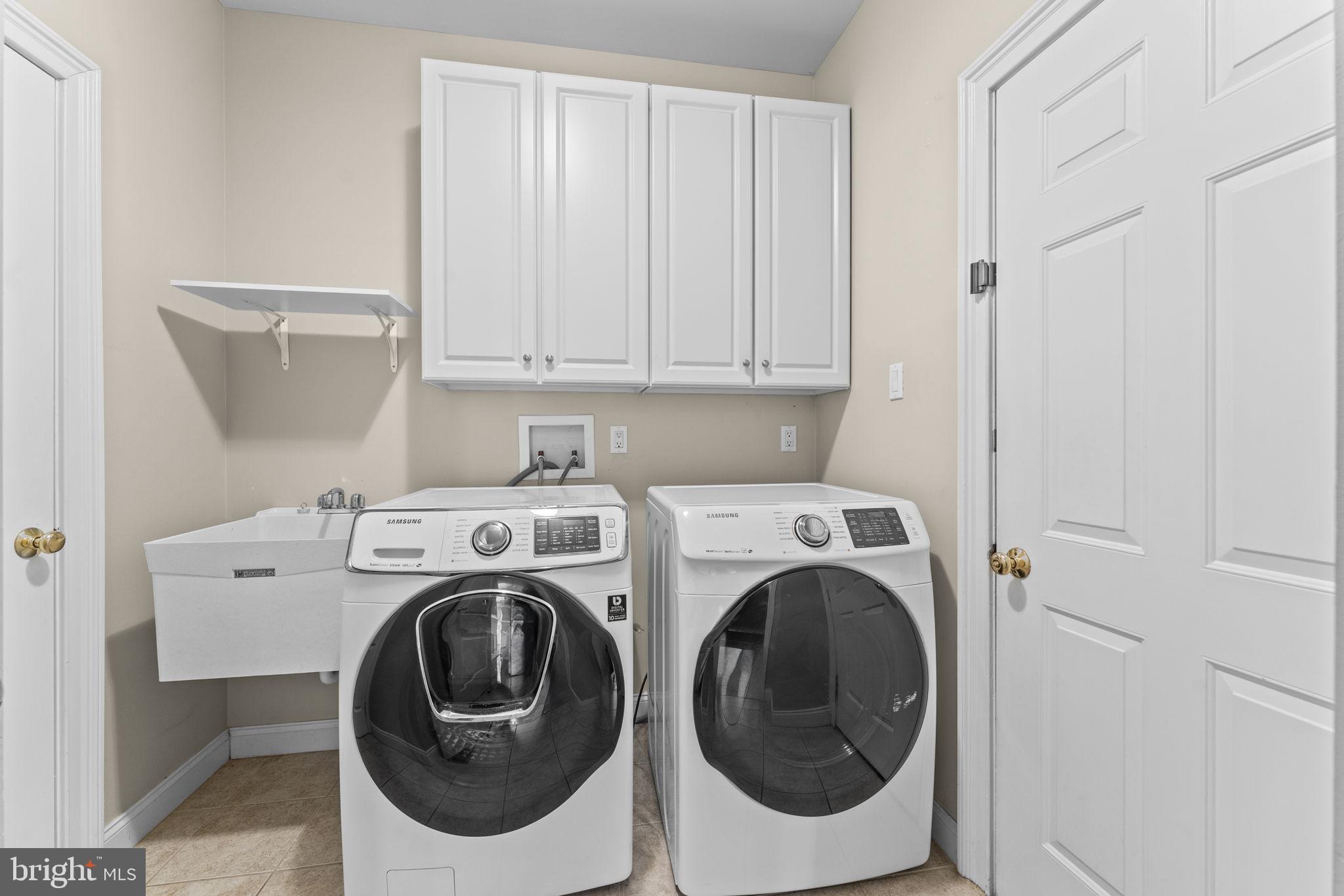 14 Sloan Road West Chester, PA 19382 - Photo 17 of 78 laundry room with cabinets and laundry tub