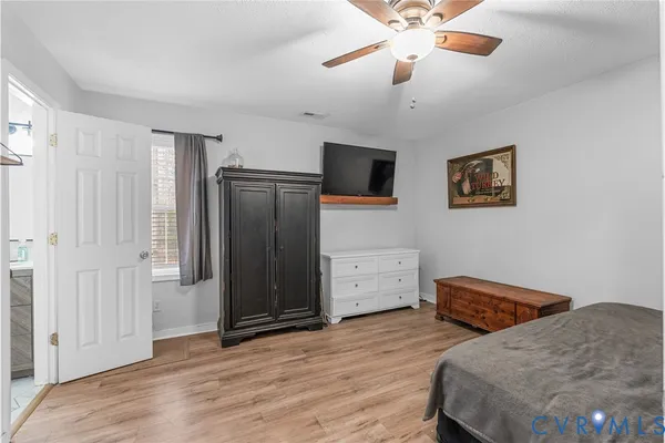 a bedroom with a bed and a ceiling fan