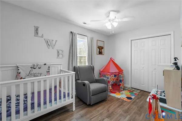 a bedroom with furniture and wooden floor