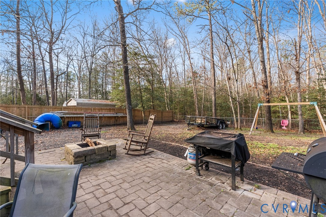 904 Rosebud Run Aylett, VA 23009 - Photo 19 of 20 a view of a patio with a table and chairs