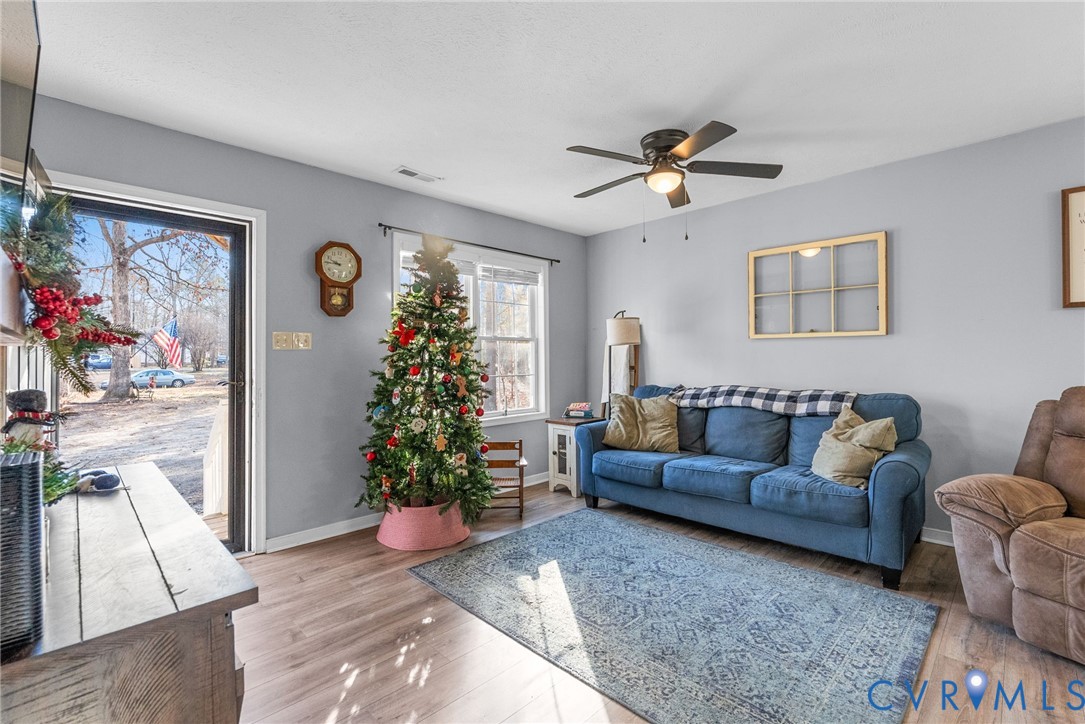 904 Rosebud Run Aylett, VA 23009 - Photo 4 of 20 a living room with furniture flower pot and wooden floor