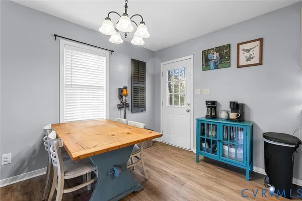 a view of a dining room with furniture wooden floor and chandelier