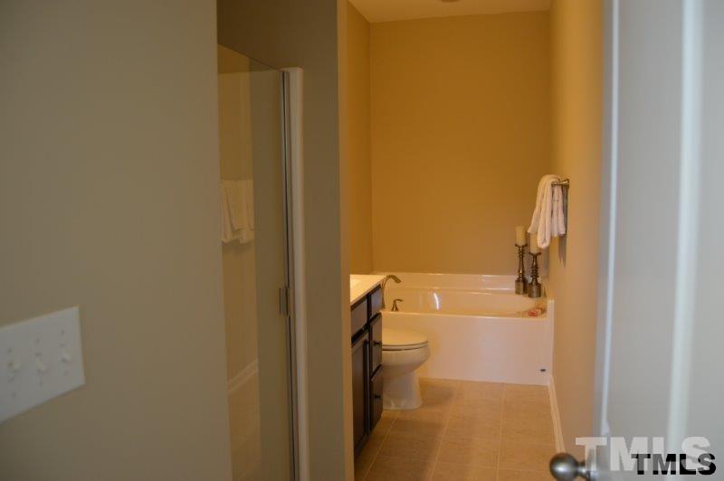 694 Wickham Ridge Road, Unit 139 Apex, NC 27539 - Photo 17 of 25 Large garden tub and stand up shower with 2 sinks.