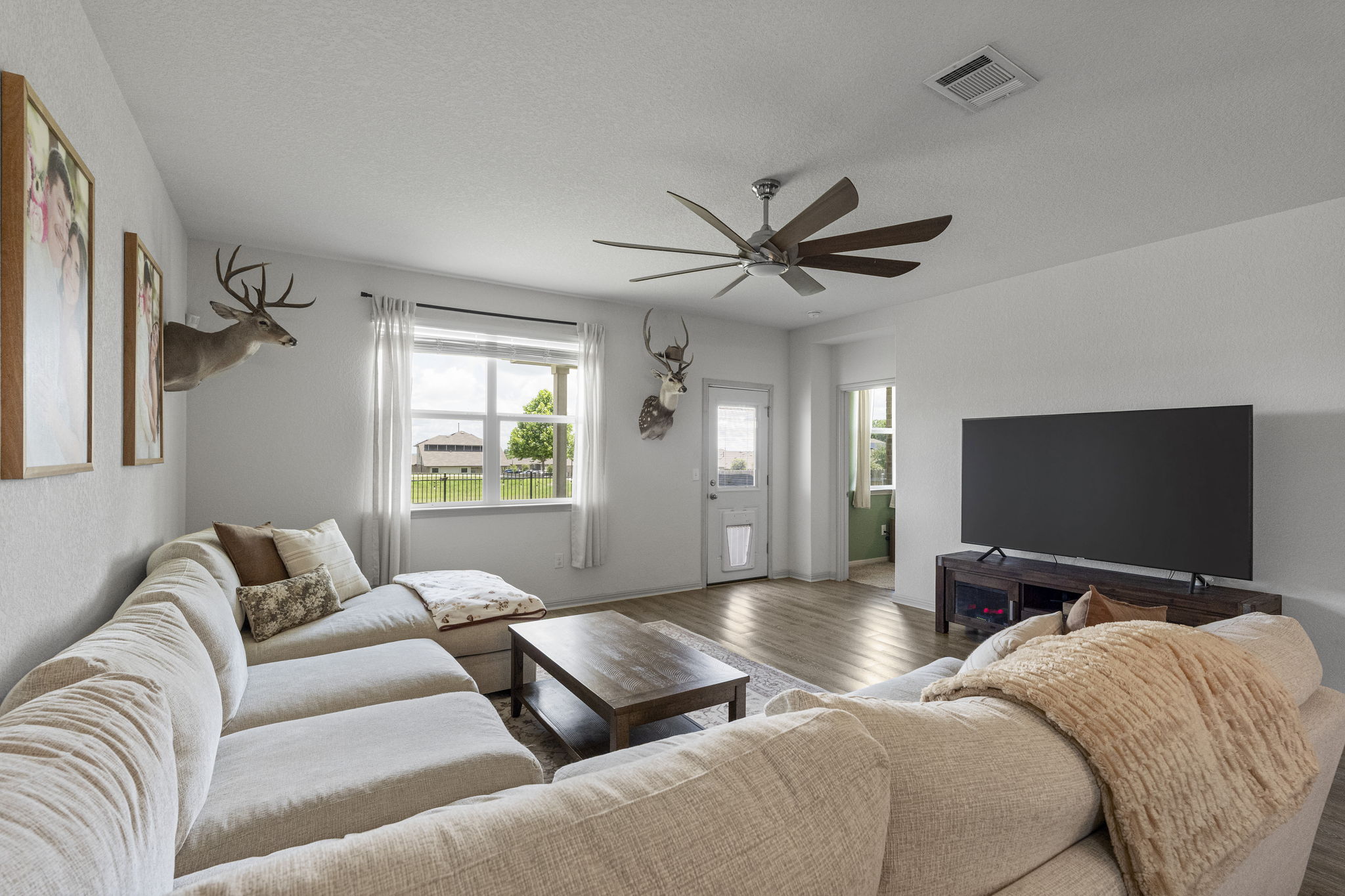 185 Struss Drive Georgetown, TX 78626 - Photo 11 of 23 A relaxed living area boasts a wide window overlooking green space and an airy overhead fan.