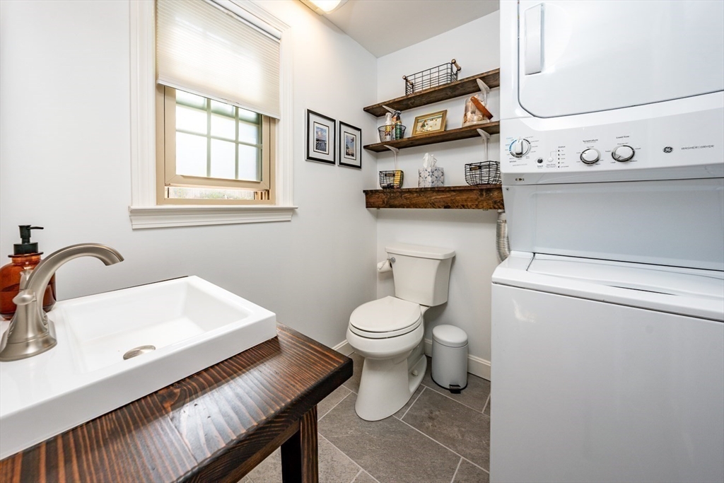 141 Main Street, Unit TH1 Dennis, MA 02660 - Photo 11 of 27 a bathroom with a sink a toilet and a window