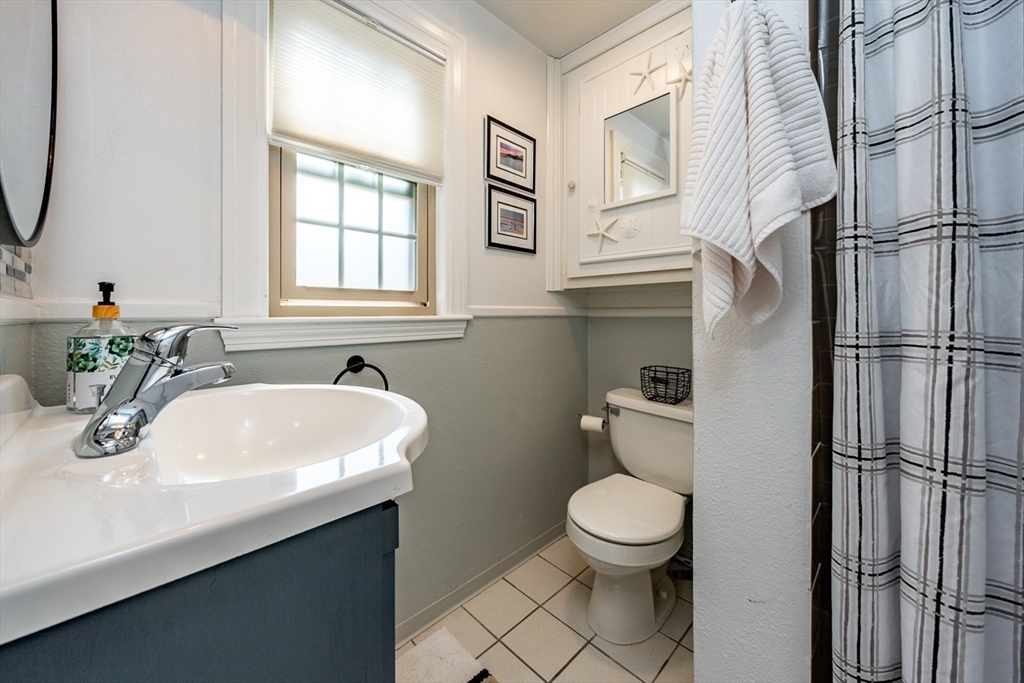 141 Main Street, Unit TH1 Dennis, MA 02660 - Photo 13 of 27 a bathroom with a sink a toilet and a mirror