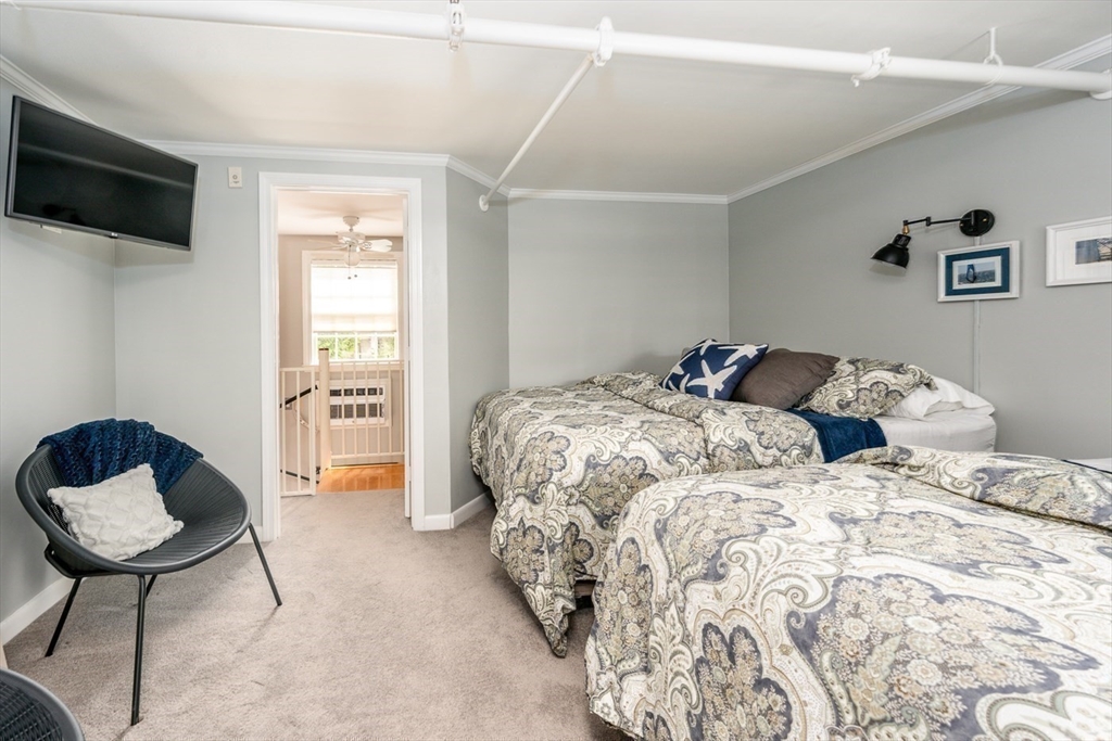 141 Main Street, Unit TH1 Dennis, MA 02660 - Photo 14 of 27 a bedroom with a bed and a window