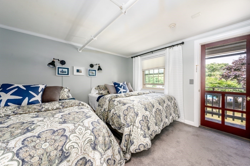 141 Main Street, Unit TH1 Dennis, MA 02660 - Photo 16 of 27 a bedroom with two beds and a large window
