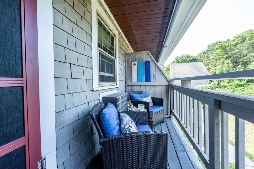 141 Main Street, Unit TH1 Dennis, MA 02660 - Photo 17 of 27 a view of balcony with couch and outdoor seating