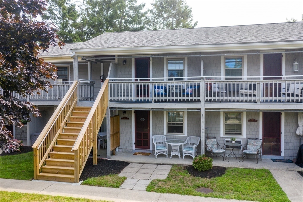 141 Main Street, Unit TH1 Dennis, MA 02660 - Photo 19 of 27 a front view of house with a garden and patio