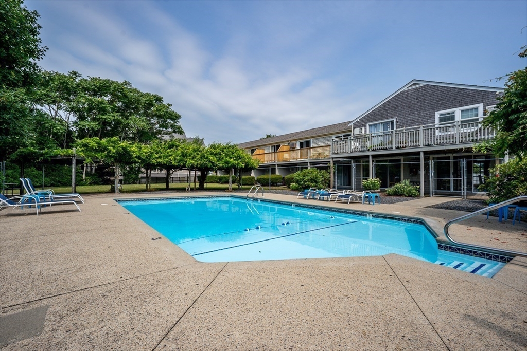 141 Main Street, Unit TH1 Dennis, MA 02660 - Photo 21 of 27 a view of a house with swimming pool