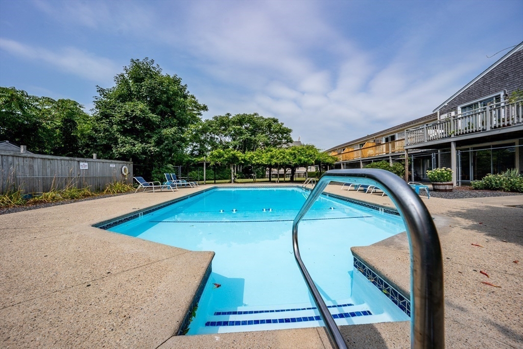 141 Main Street, Unit TH1 Dennis, MA 02660 - Photo 22 of 27 a view of a swimming pool with a patio