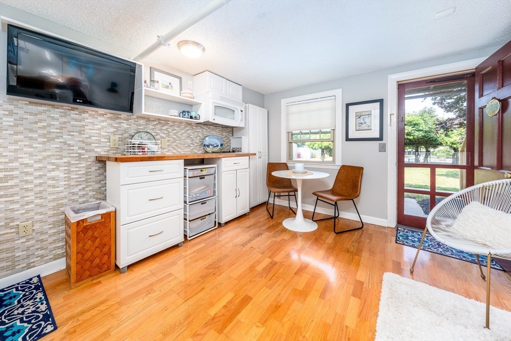 141 Main Street, Unit TH1 Dennis, MA 02660 - Photo 3 of 27 a living room with furniture and a flat screen tv