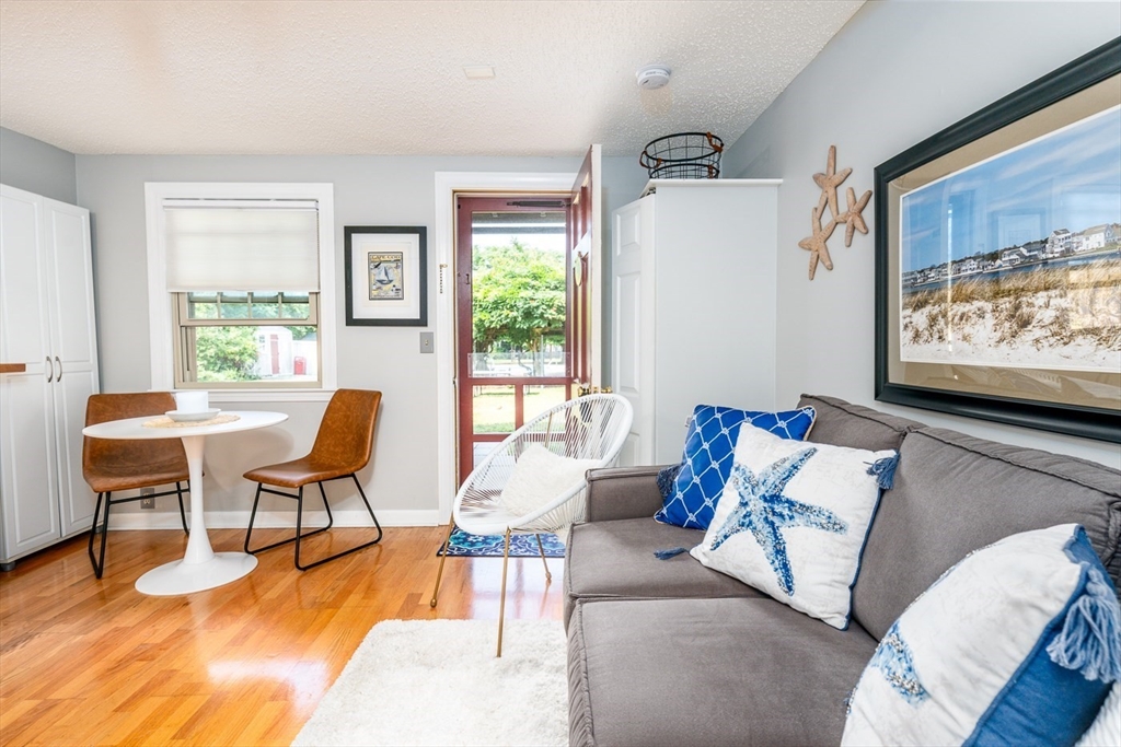 141 Main Street, Unit TH1 Dennis, MA 02660 - Photo 4 of 27 a living room with furniture and a flat screen tv