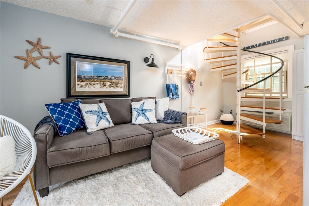141 Main Street, Unit TH1 Dennis, MA 02660 - Photo 5 of 27 a living room with furniture and a flat screen tv