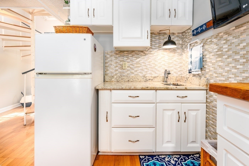 141 Main Street, Unit TH1 Dennis, MA 02660 - Photo 8 of 27 a bathroom with a sink a toilet and a mirror