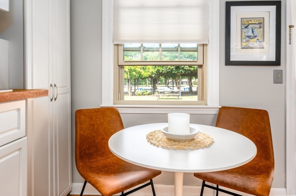 141 Main Street, Unit TH1 Dennis, MA 02660 - Photo 10 of 27 a dining room with furniture and a window