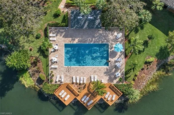 an aerial view of a house with a garden and lake view