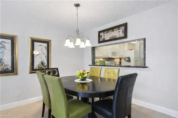 a view of a dining room with furniture and chandelier