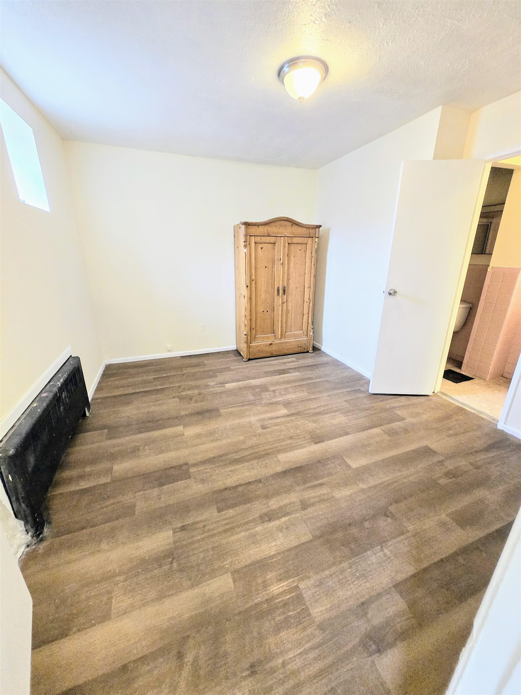2015 Summit Avenue, Unit B1 Union City, NJ 07087 - Photo 5 of 5 a view of an empty room with wooden floor and a window
