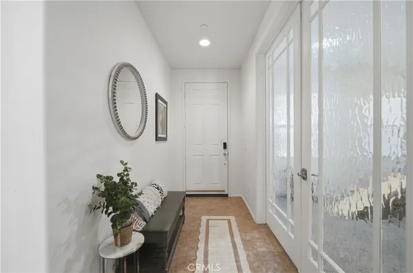 a view of a room with wooden floor and mirror