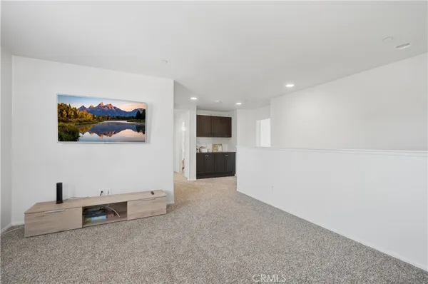 a spacious bedroom with a bed and a large window