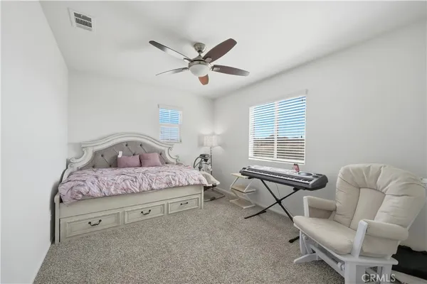 a view of a livingroom with a ceiling fan and window