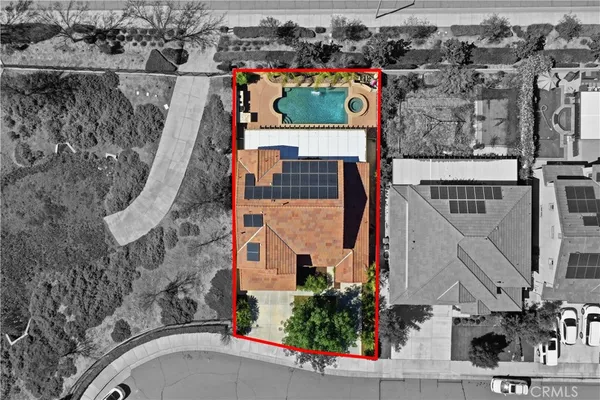 an aerial view of a house with a garden and trees