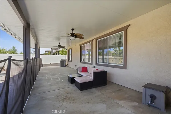 a view of a living room and balcony with furniture