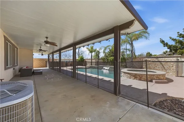 a swimming pool with outdoor seating and yard