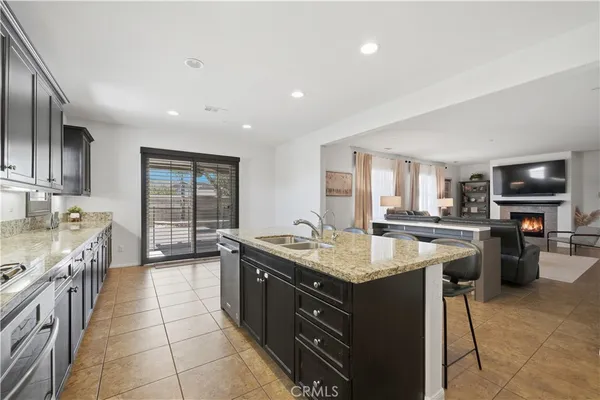 a kitchen with a stove sink and cabinets