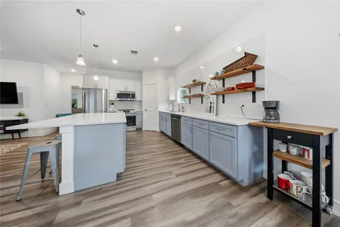a kitchen with kitchen island cabinets and a wooden floor