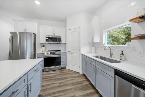 a kitchen with a sink stove and refrigerator