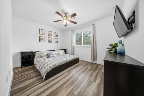 a bedroom with a large bed and a chandelier