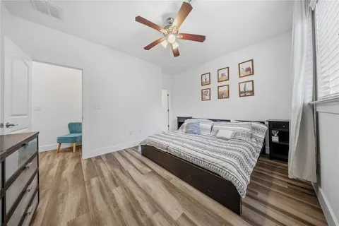 a bedroom with a bed and a ceiling fan