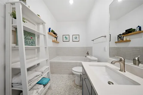 a bathroom with a sink a toilet and bathtub